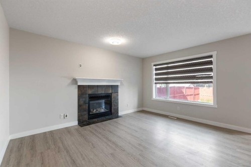 124 Saddlecrest Boulevard Ne, Calgary, AB - Indoor Photo Showing Living Room With Fireplace