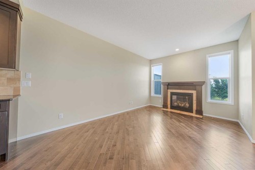 48 Panatella Common Nw, Calgary, AB - Indoor Photo Showing Living Room With Fireplace
