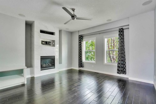 145 Marquis Common Se, Calgary, AB - Indoor Photo Showing Living Room With Fireplace