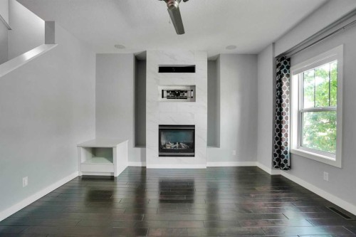 145 Marquis Common Se, Calgary, AB - Indoor Photo Showing Other Room With Fireplace