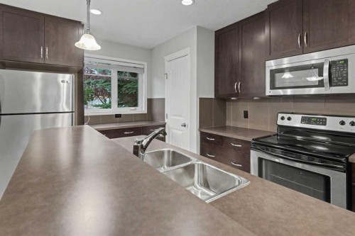 127 Prestwick Villas Se, Calgary, AB - Indoor Photo Showing Kitchen With Stainless Steel Kitchen With Double Sink