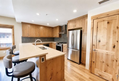 209-707 Spring Creek Drive, Canmore, AB - Indoor Photo Showing Kitchen With Double Sink