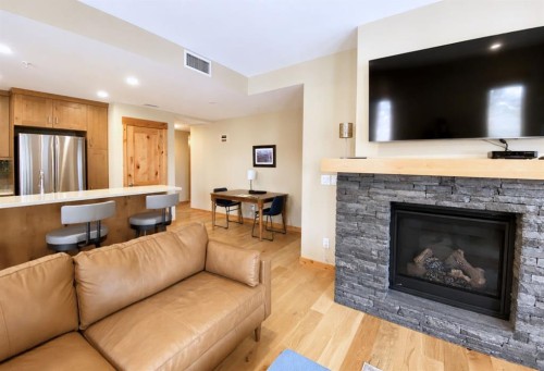 209-707 Spring Creek Drive, Canmore, AB - Indoor Photo Showing Living Room With Fireplace