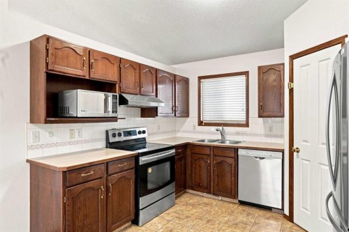 279 Coral Springs Circle Ne, Calgary, AB - Indoor Photo Showing Kitchen With Stainless Steel Kitchen With Double Sink