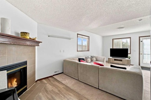 279 Coral Springs Circle Ne, Calgary, AB - Indoor Photo Showing Living Room With Fireplace