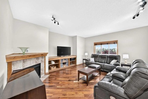 145 Panamount Place Nw, Calgary, AB - Indoor Photo Showing Living Room With Fireplace