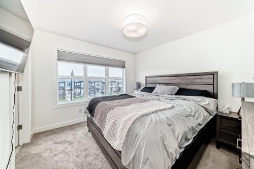 109-525 River Heights Drive, Cochrane, AB - Indoor Photo Showing Bedroom