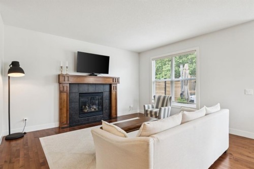 70 Cortina Way Sw, Calgary, AB - Indoor Photo Showing Living Room With Fireplace