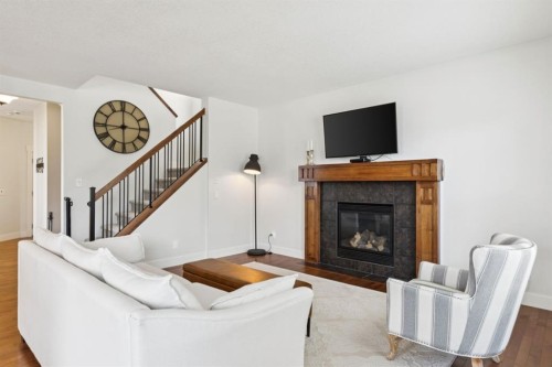 70 Cortina Way Sw, Calgary, AB - Indoor Photo Showing Living Room With Fireplace