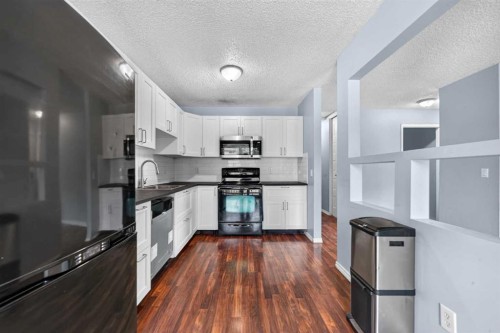 12-14736 Deerfield Drive Se, Calgary, AB - Indoor Photo Showing Kitchen With Upgraded Kitchen