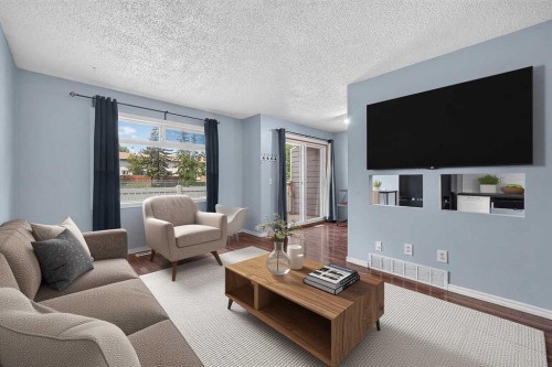 12-14736 Deerfield Drive Se, Calgary, AB - Indoor Photo Showing Living Room