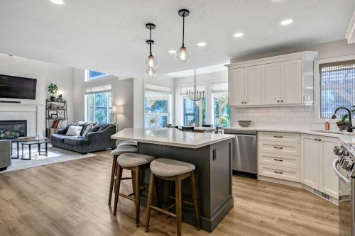 9 Sheep River Heath, Okotoks, AB - Indoor Photo Showing Kitchen With Fireplace With Stainless Steel Kitchen With Upgraded Kitchen