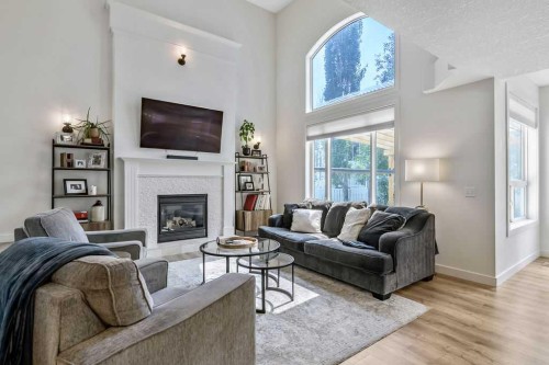 9 Sheep River Heath, Okotoks, AB - Indoor Photo Showing Living Room With Fireplace