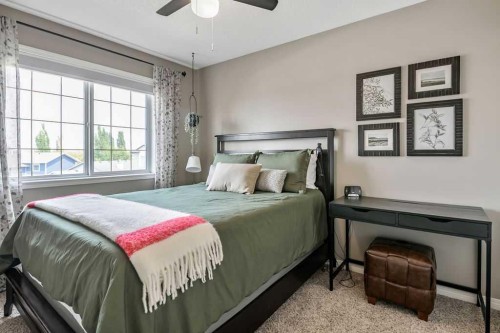 9 Sheep River Heath, Okotoks, AB - Indoor Photo Showing Bedroom