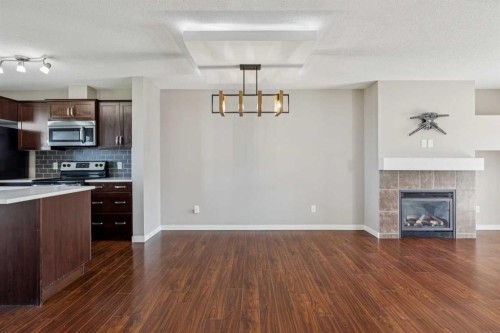 409 Copperpond Landing Se, Calgary, AB - Indoor Photo Showing Kitchen With Fireplace