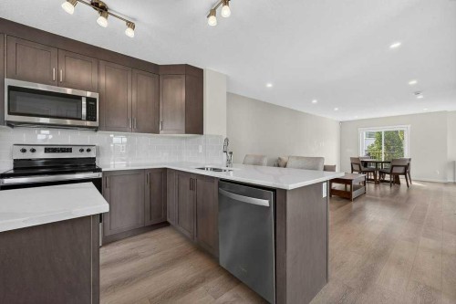 709-474 Seton Circle Se, Calgary, AB - Indoor Photo Showing Kitchen With Stainless Steel Kitchen With Double Sink With Upgraded Kitchen
