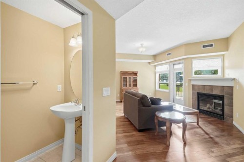 2144-48 Inverness Gate Se, Calgary, AB - Indoor Photo Showing Living Room With Fireplace