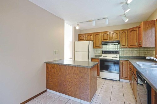 52 Edgeland Road Nw, Calgary, AB - Indoor Photo Showing Kitchen With Double Sink
