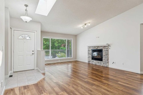 159 Woodbend Way, Okotoks, AB - Indoor Photo Showing Living Room With Fireplace