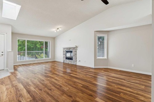 159 Woodbend Way, Okotoks, AB - Indoor Photo Showing Living Room With Fireplace