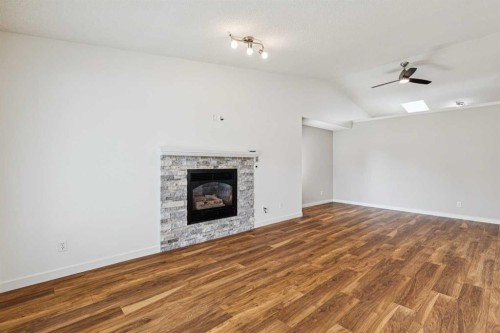 159 Woodbend Way, Okotoks, AB - Indoor Photo Showing Living Room With Fireplace