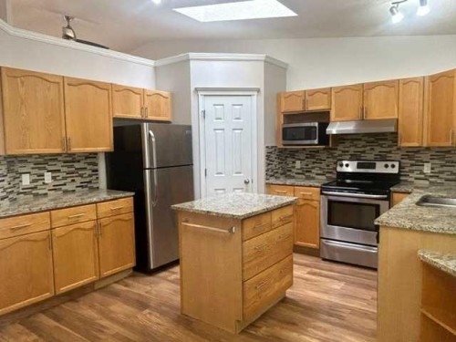 159 Woodbend Way, Okotoks, AB - Indoor Photo Showing Kitchen With Stainless Steel Kitchen