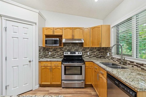 159 Woodbend Way, Okotoks, AB - Indoor Photo Showing Kitchen With Stainless Steel Kitchen With Double Sink