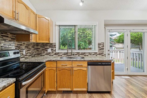 159 Woodbend Way, Okotoks, AB - Indoor Photo Showing Kitchen With Double Sink
