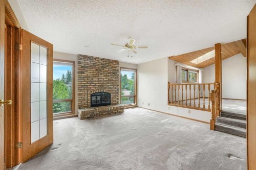 9144 Oakmount Drive Sw, Calgary, AB - Indoor Photo Showing Living Room With Fireplace
