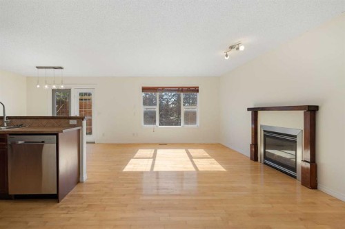 78 Cougar Plateau Way Sw, Calgary, AB - Indoor Photo Showing Other Room With Fireplace