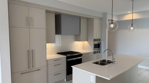 609-8370 Broadcast Avenue Sw, Calgary, AB - Indoor Photo Showing Kitchen With Double Sink With Upgraded Kitchen