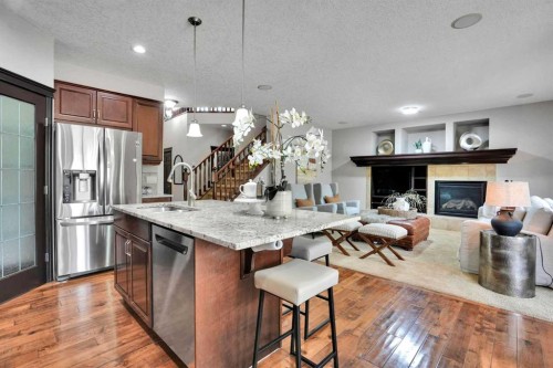 212 Everbrook Way Sw, Calgary, AB - Indoor Photo Showing Kitchen With Fireplace With Stainless Steel Kitchen With Upgraded Kitchen