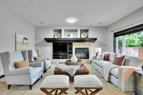 212 Everbrook Way Sw, Calgary, AB - Indoor Photo Showing Living Room With Fireplace