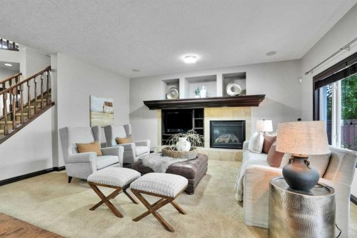 212 Everbrook Way Sw, Calgary, AB - Indoor Photo Showing Living Room With Fireplace