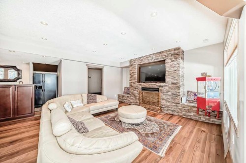 40 Cougar Ridge Heights Sw, Calgary, AB - Indoor Photo Showing Living Room With Fireplace