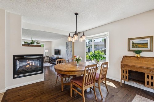 423 Canterbury Place Sw, Calgary, AB - Indoor Photo Showing Dining Room With Fireplace