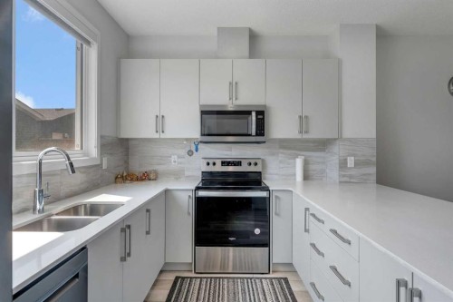 97 Corner Glen Way Ne, Calgary, AB - Indoor Photo Showing Kitchen With Stainless Steel Kitchen With Double Sink With Upgraded Kitchen