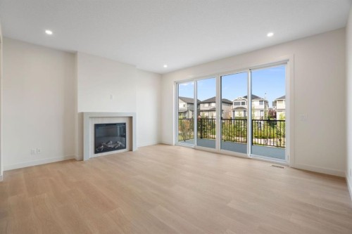 112 Sunrise Heath, Cochrane, AB - Indoor Photo Showing Living Room With Fireplace