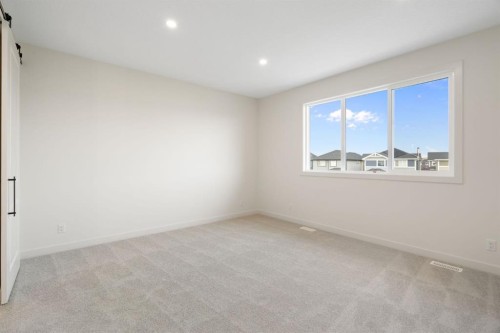 112 Sunrise Heath, Cochrane, AB - Indoor Photo Showing Other Room