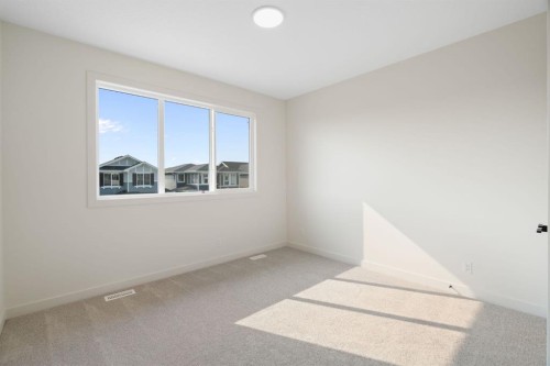 112 Sunrise Heath, Cochrane, AB - Indoor Photo Showing Other Room