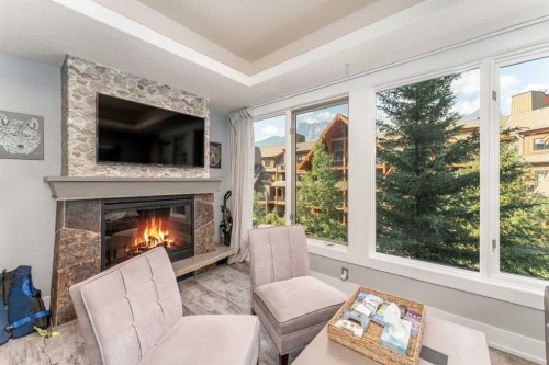 213-173 Kananaskis Way, Canmore, AB - Indoor Photo Showing Living Room With Fireplace