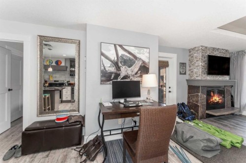 213-173 Kananaskis Way, Canmore, AB - Indoor Photo Showing Other Room With Fireplace