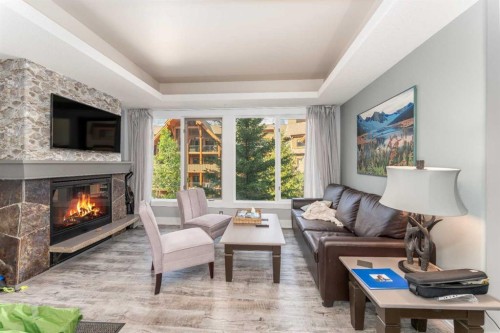 213-173 Kananaskis Way, Canmore, AB - Indoor Photo Showing Living Room With Fireplace