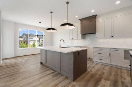 116 Sunrise Heath, Cochrane, AB - Indoor Photo Showing Kitchen With Upgraded Kitchen