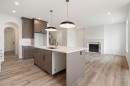116 Sunrise Heath, Cochrane, AB  - Indoor Photo Showing Kitchen With Upgraded Kitchen 