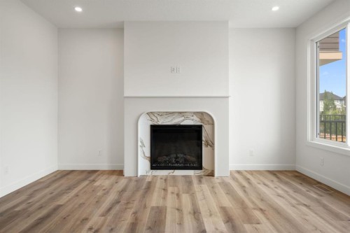 116 Sunrise Heath, Cochrane, AB - Indoor Photo Showing Living Room With Fireplace