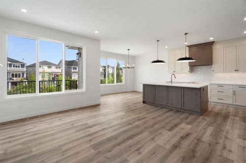 116 Sunrise Heath, Cochrane, AB - Indoor Photo Showing Kitchen With Upgraded Kitchen