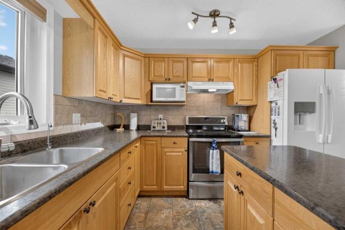41 Deer Coulee Drive, Didsbury, AB - Indoor Photo Showing Kitchen With Double Sink