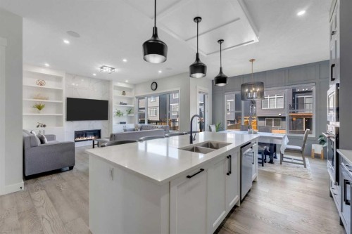 32 Waterford Terrace, Chestermere, AB - Indoor Photo Showing Kitchen With Fireplace With Double Sink With Upgraded Kitchen
