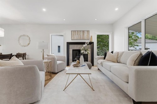 12 Prominence Point Sw, Calgary, AB - Indoor Photo Showing Living Room With Fireplace